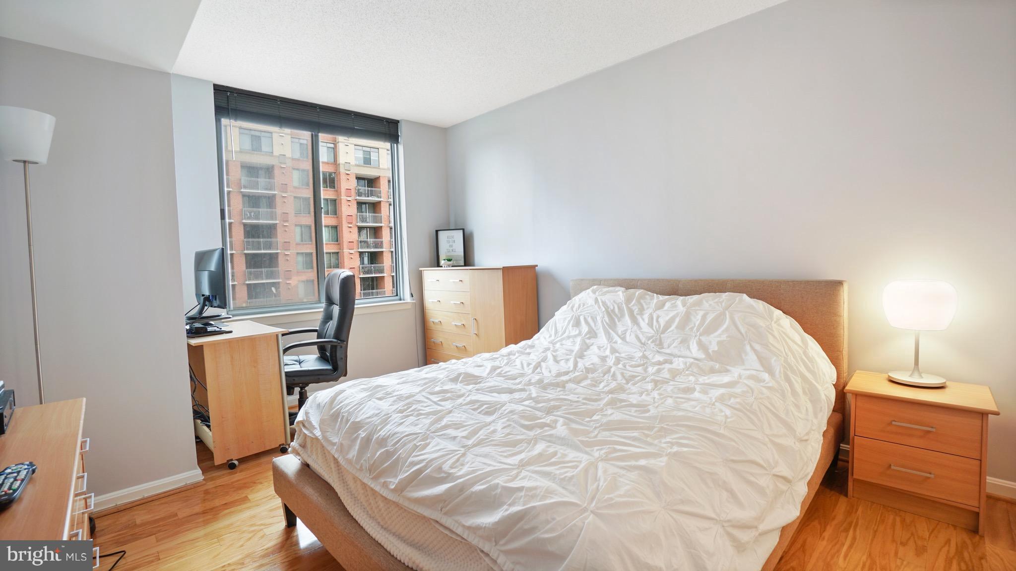 11710 Old Georgetown Road, Unit 1026 Rockville, MD 20852 - Photo 11 of 22 a large bed sitting in a bedroom next to a window