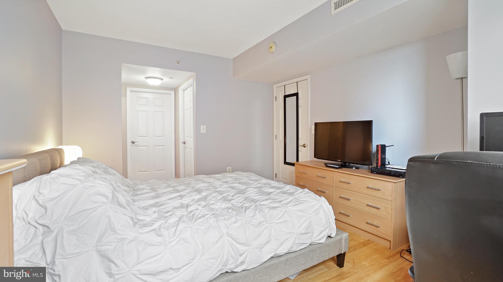 11710 Old Georgetown Road, Unit 1026 Rockville, MD 20852 - Photo 12 of 22 a bedroom with a bed and a flat screen tv