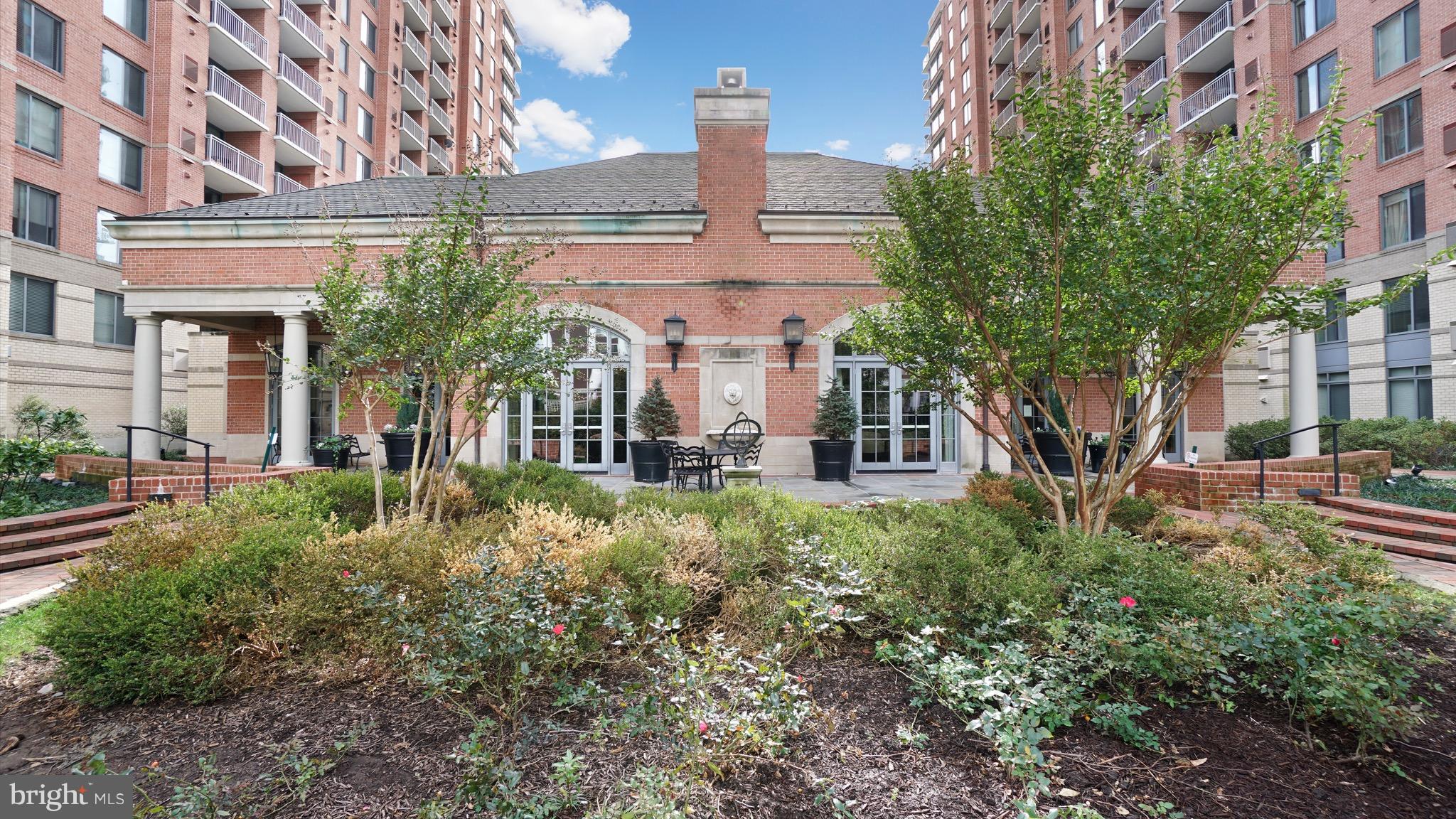 11710 Old Georgetown Road, Unit 1026 Rockville, MD 20852 - Photo 17 of 22 a view of a building with a yard and fountain in front of it