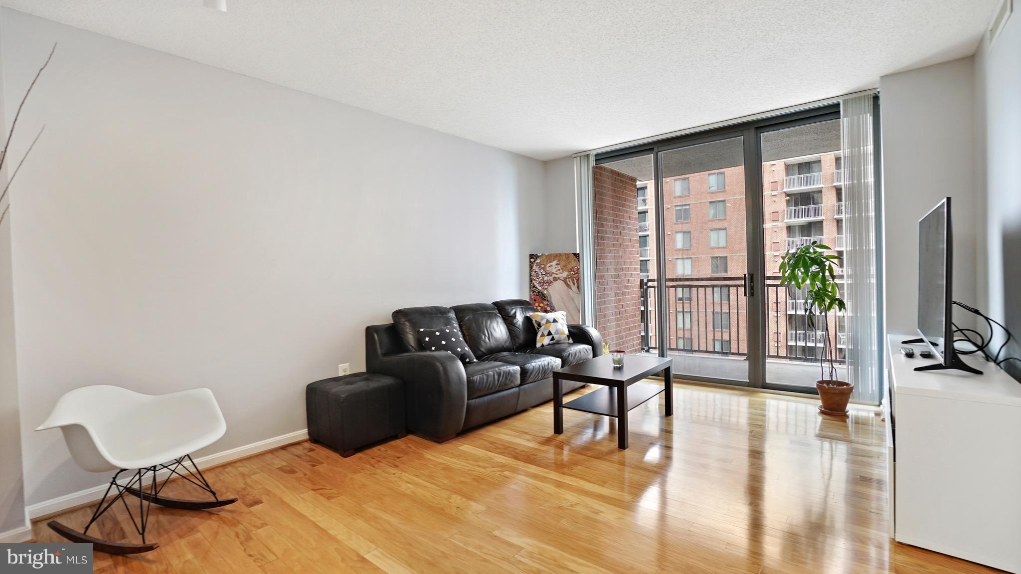 11710 Old Georgetown Road, Unit 1026 Rockville, MD 20852 - Photo 5 of 22 a living room with furniture and a flat screen tv