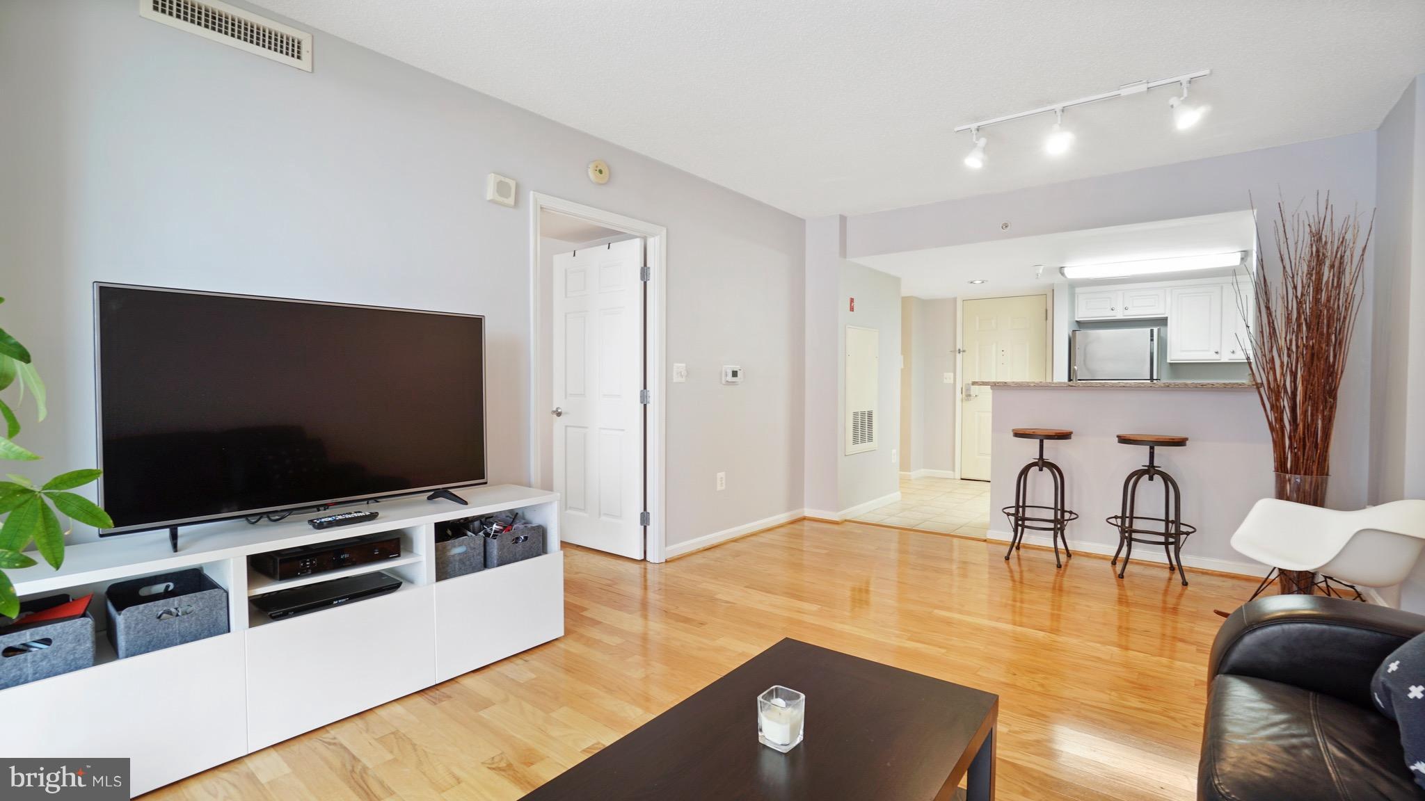 11710 Old Georgetown Road, Unit 1026 Rockville, MD 20852 - Photo 7 of 22 a living room with furniture and a flat screen tv