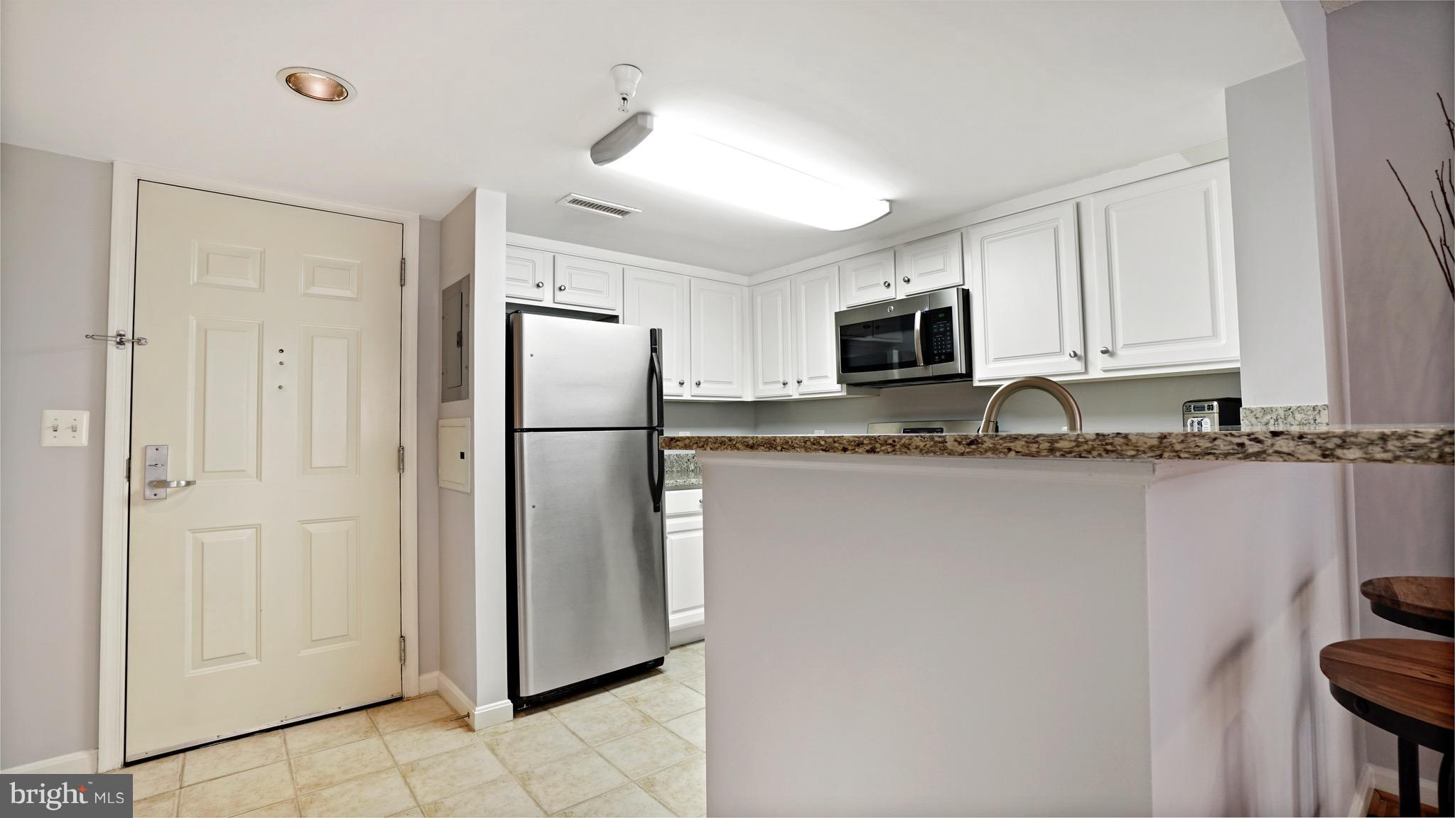 11710 Old Georgetown Road, Unit 1026 Rockville, MD 20852 - Photo 9 of 22 a metallic refrigerator freezer sitting in a kitchen