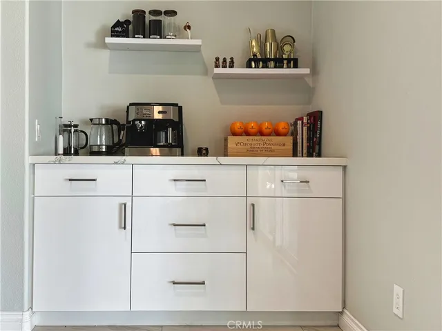 a kitchen with white cabinets and white appliances