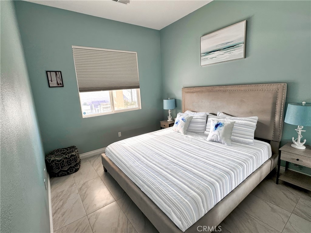 43244 Freesia Place Indio, CA 92201 - Photo 14 of 17 a bedroom with a bed and a window
