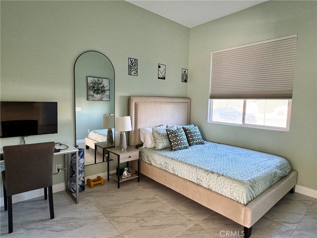 43244 Freesia Place Indio, CA 92201 - Photo 15 of 17 a bedroom with a bed and a flat screen tv