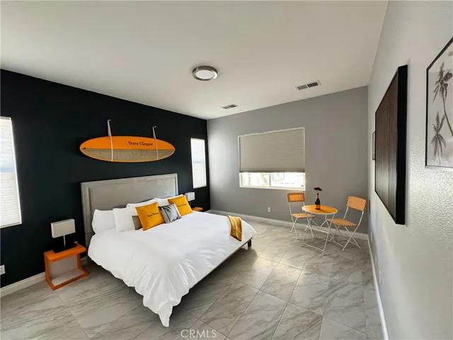 a bedroom with a bed and a chair