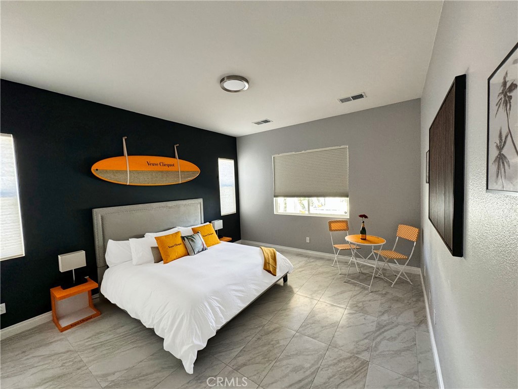 43244 Freesia Place Indio, CA 92201 - Photo 4 of 17 a bedroom with a bed and a chair