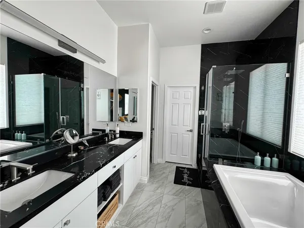 a large bathroom with a double vanity sink and mirror
