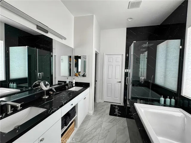 a large bathroom with a double vanity sink and mirror