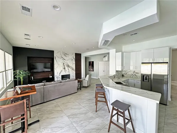 a living room with fireplace furniture and a flat screen tv