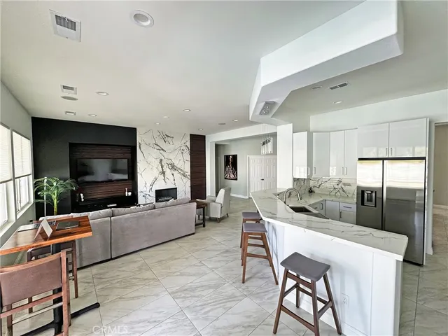 a living room with fireplace furniture and a flat screen tv