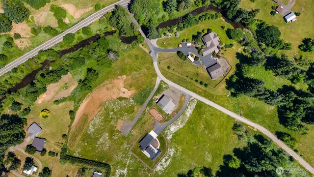 an aerial view of residential houses with outdoor space and swimming pool