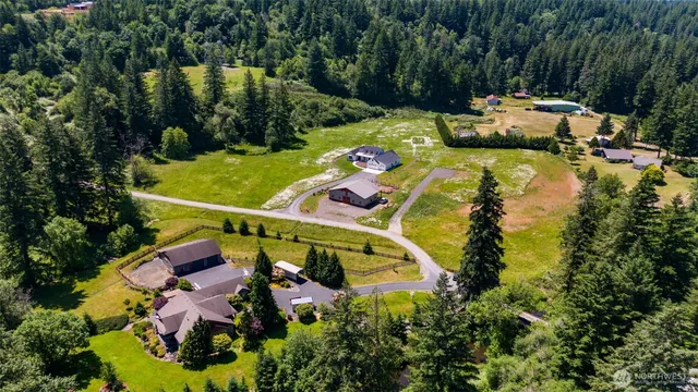an aerial view of residential houses with outdoor space and swimming pool