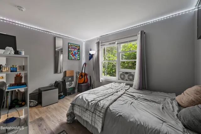 a bedroom with a bed and a large window