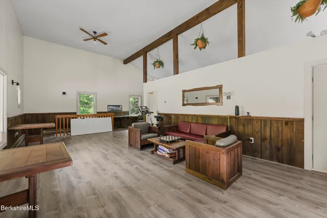 a living room with furniture and wooden floor