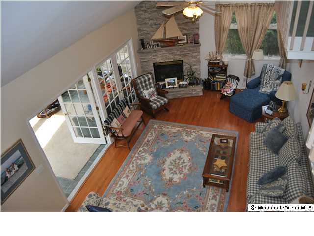 2105 Miller Road Point Pleasant, NJ 08742 - Photo 3 of 12 a living room with furniture a fireplace and a flat screen tv