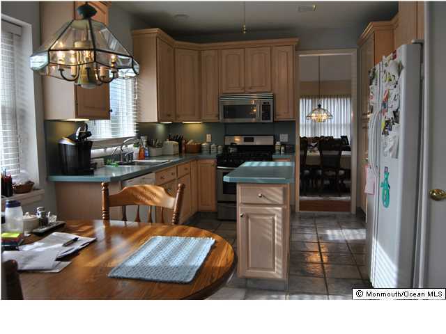 2105 Miller Road Point Pleasant, NJ 08742 - Photo 4 of 12 a kitchen with stainless steel appliances kitchen island granite countertop a stove top oven a sink a counter space and cabinets