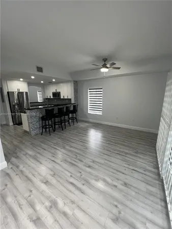 a view of a room with wooden floor