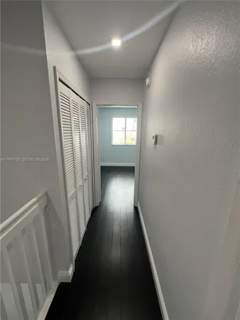 a view of room with hardwood floor and window