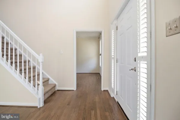 a view of entryway and hall with wooden floor