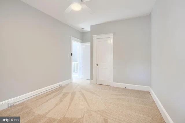 an empty room with windows and closet