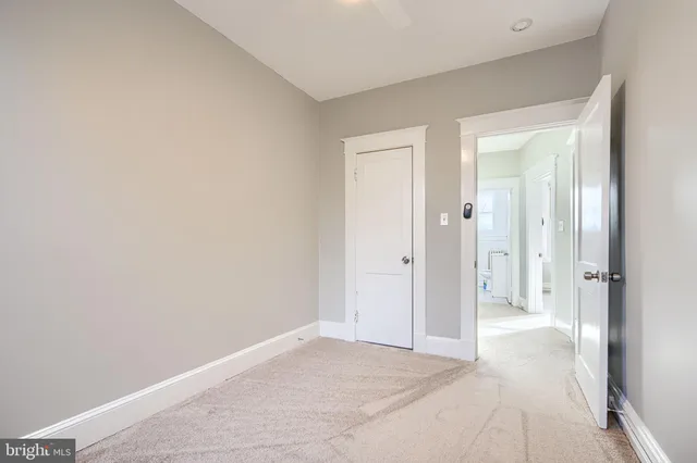 a view of porch with a floor to ceiling window and wooden fence