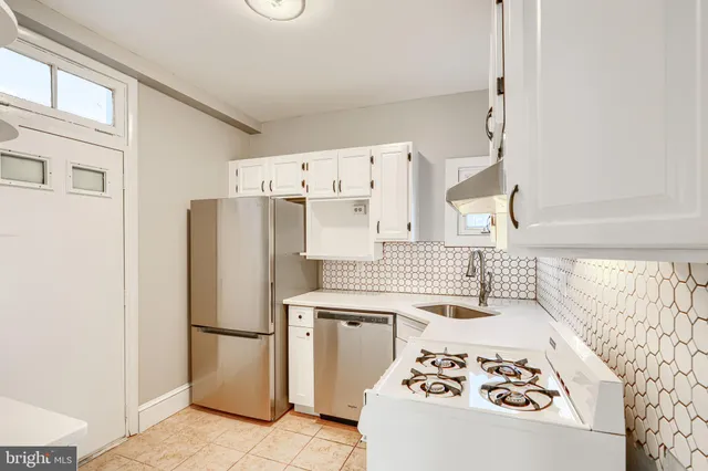 a kitchen with a refrigerator and a stove