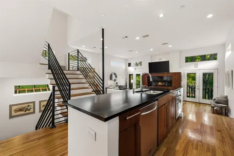 a kitchen with stainless steel appliances granite countertop a stove and a refrigerator