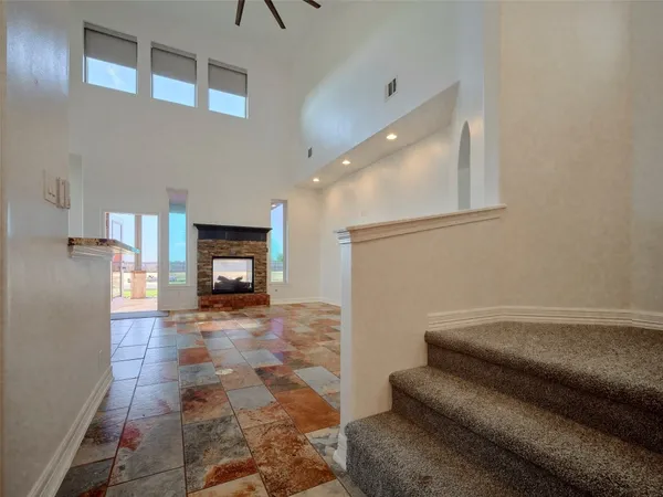 a view of an empty room with a fireplace