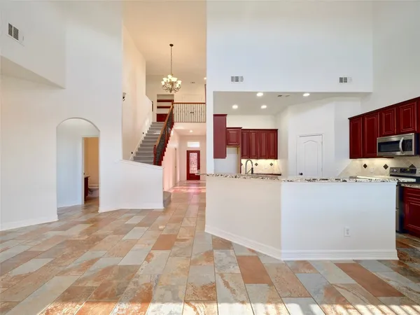 a bathroom with a granite countertop sink and a toilet