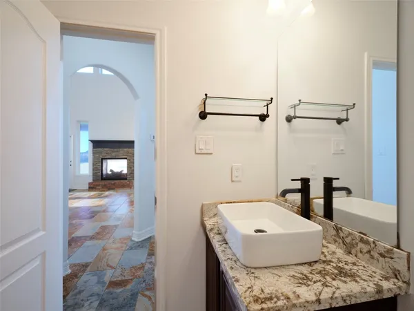 a view of a hallway with wooden floor and cabinet