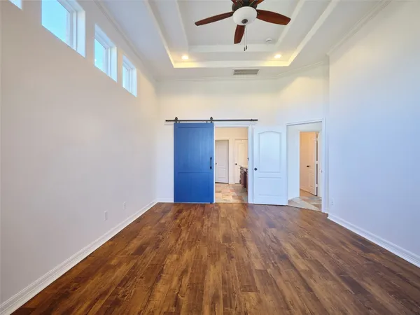 an empty room with a ceiling fan and a window