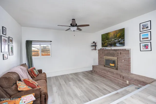 a living room with furniture a flat screen tv and a fireplace