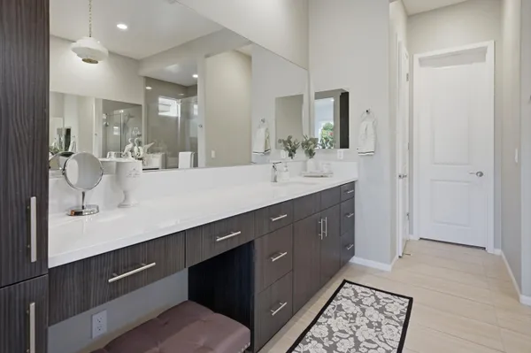 a bathroom with a tub a sink and mirror