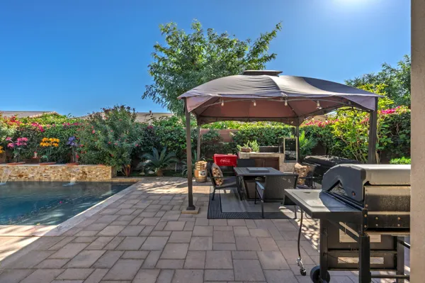 a view of a patio with couches chairs and potted plants