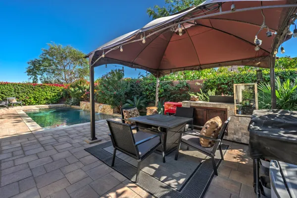 a view of a chairs and table in the patio