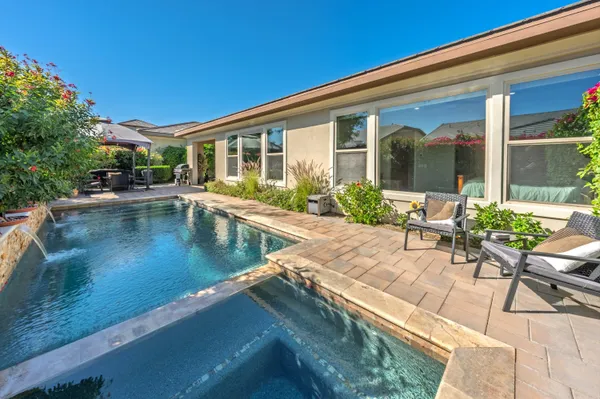 an aerial view of a house with a swimming pool outdoor seating and yard