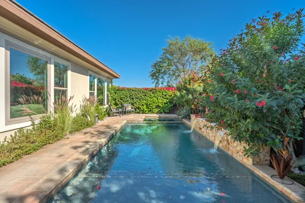 a view of a swimming pool with a yard and mountain view