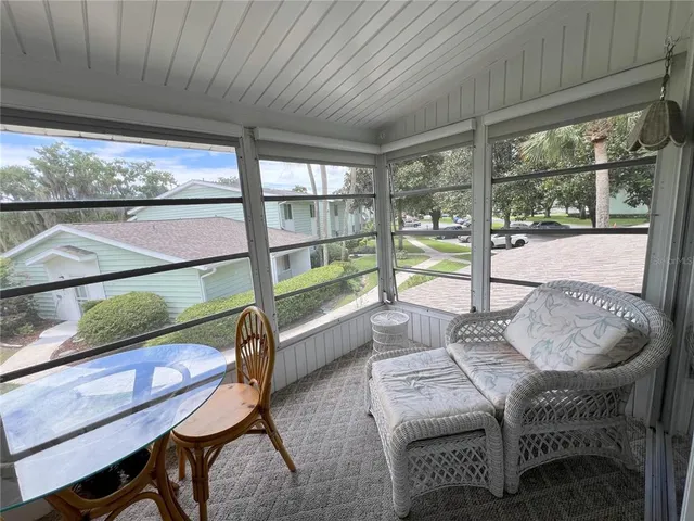 a dining room with furniture and a large window