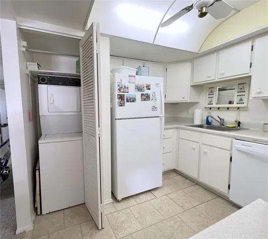 a white refrigerator freezer sitting inside of a kitchen