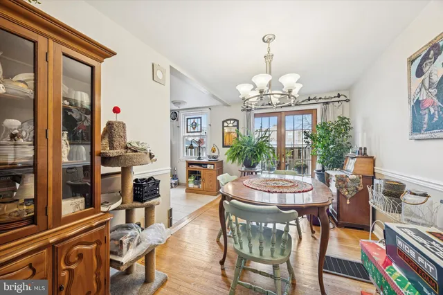 a view of a dining room with furniture a chandelier and wooden floor