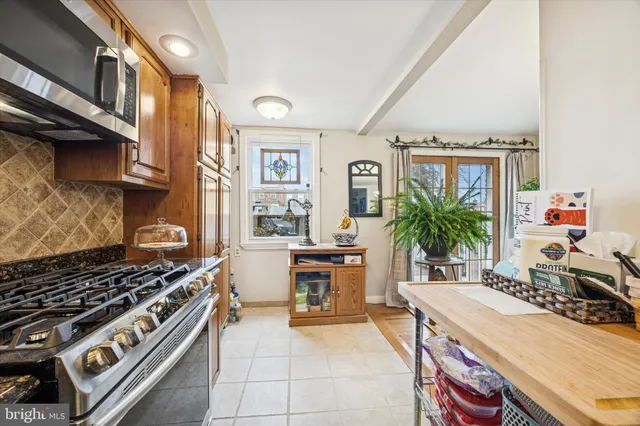a kitchen with stove and cabinets