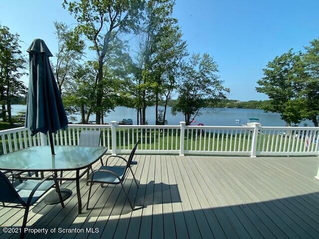 18 Power Line Road Scott Township, PA 18433 - Photo 20 of 34 a view of a deck with a table and chairs with wooden floor and fence