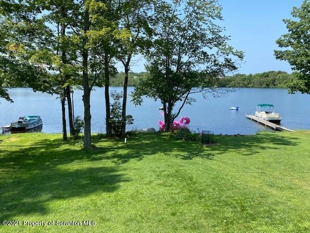 18 Power Line Road Scott Township, PA 18433 - Photo 2 of 34 a backyard of a house with table and chairs plants and large trees