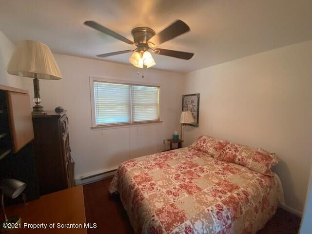 18 Power Line Road Scott Township, PA 18433 - Photo 5 of 34 a bedroom with a bed and a lamp on dresser