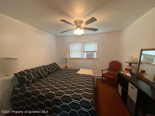 18 Power Line Road Scott Township, PA 18433 - Photo 6 of 34 a bedroom with a bed and a lamp on dresser with a chandelier