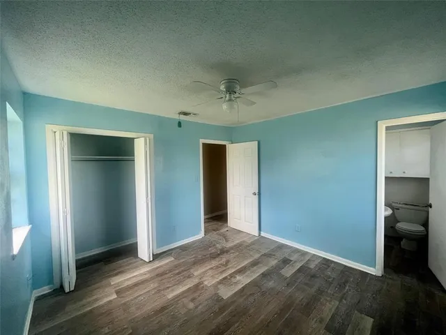 an empty room with closet and a bathroom