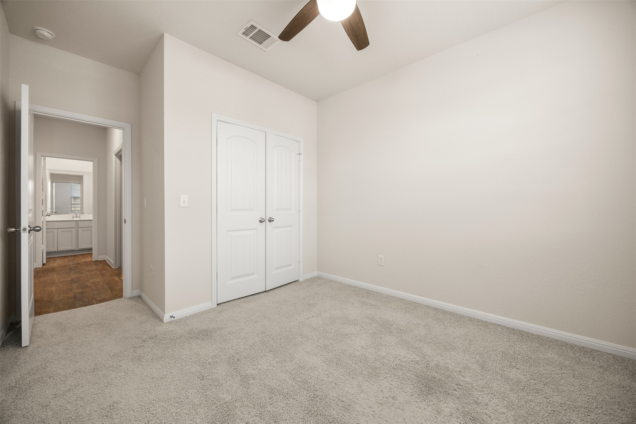 413 Emerald Cove Georgetown, TX 78626 - Photo 9 of 15 Unfurnished bedroom featuring carpet, a closet, and a ceiling fan
