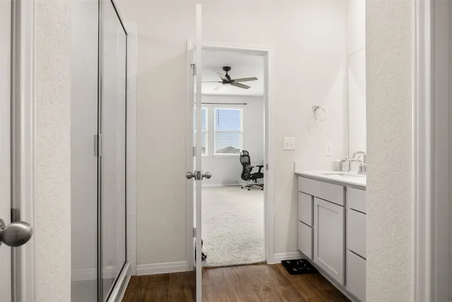 an empty room with closet and a chandelier fan