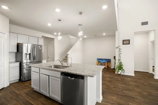 a view of a kitchen with wooden floor
